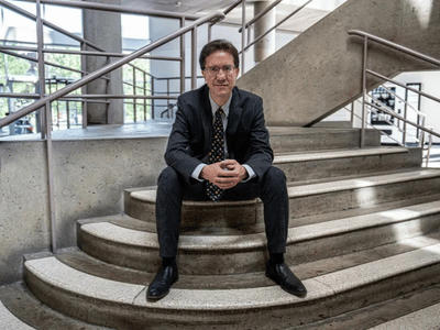 Man in a business suit sitting on stairs