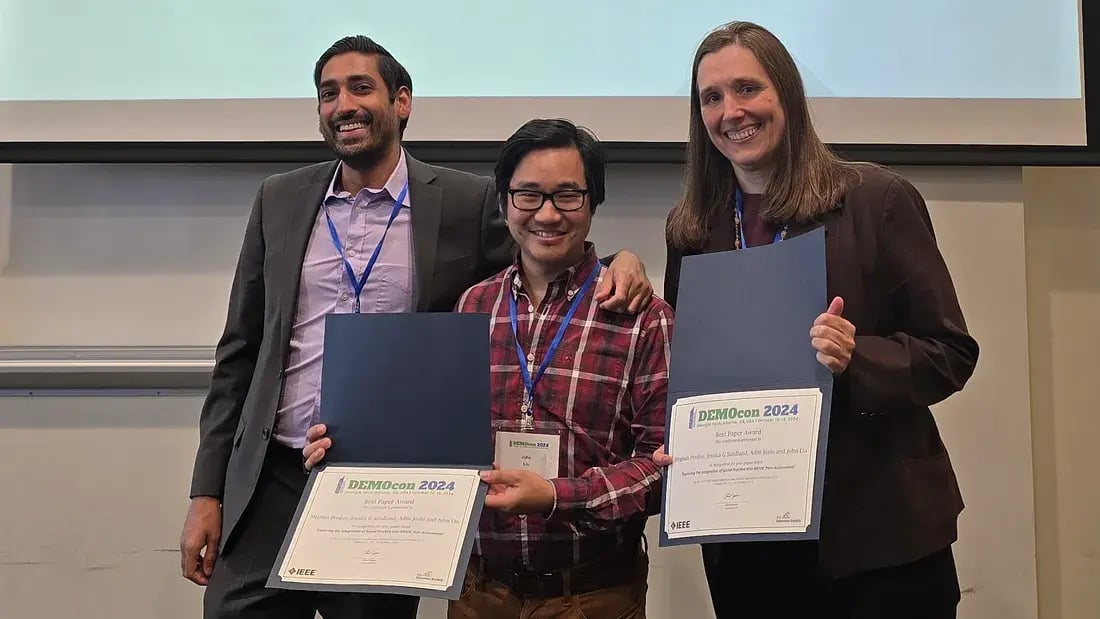 MIT Open Learning Digital Learning Scientists John Liu (center) and Jessica Sandland (right) accept the Best Paper Award at IEEE DEMOcon 2024 from Alex Duncan (left), technical program chair.