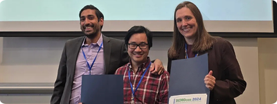 MIT Open Learning Digital Learning Scientists John Liu (center) and Jessica Sandland (right) accept the Best Paper Award at IEEE DEMOcon 2024 from Alex Duncan (left), technical program chair.