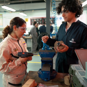 students in workshop using machinery